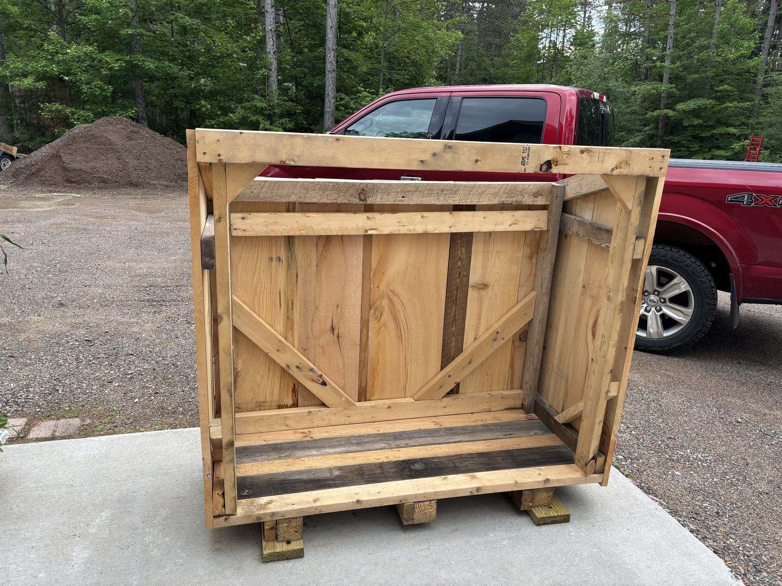 Shed frame with braced back wall sitting on skids
