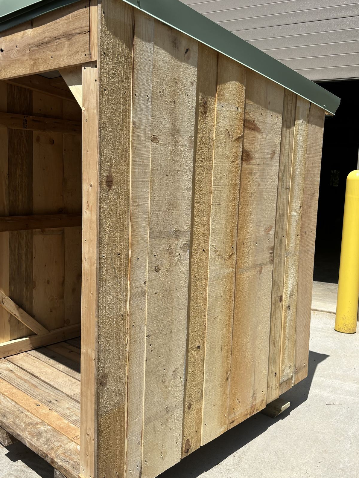 Close view of rough-sawn side boards under a green roof