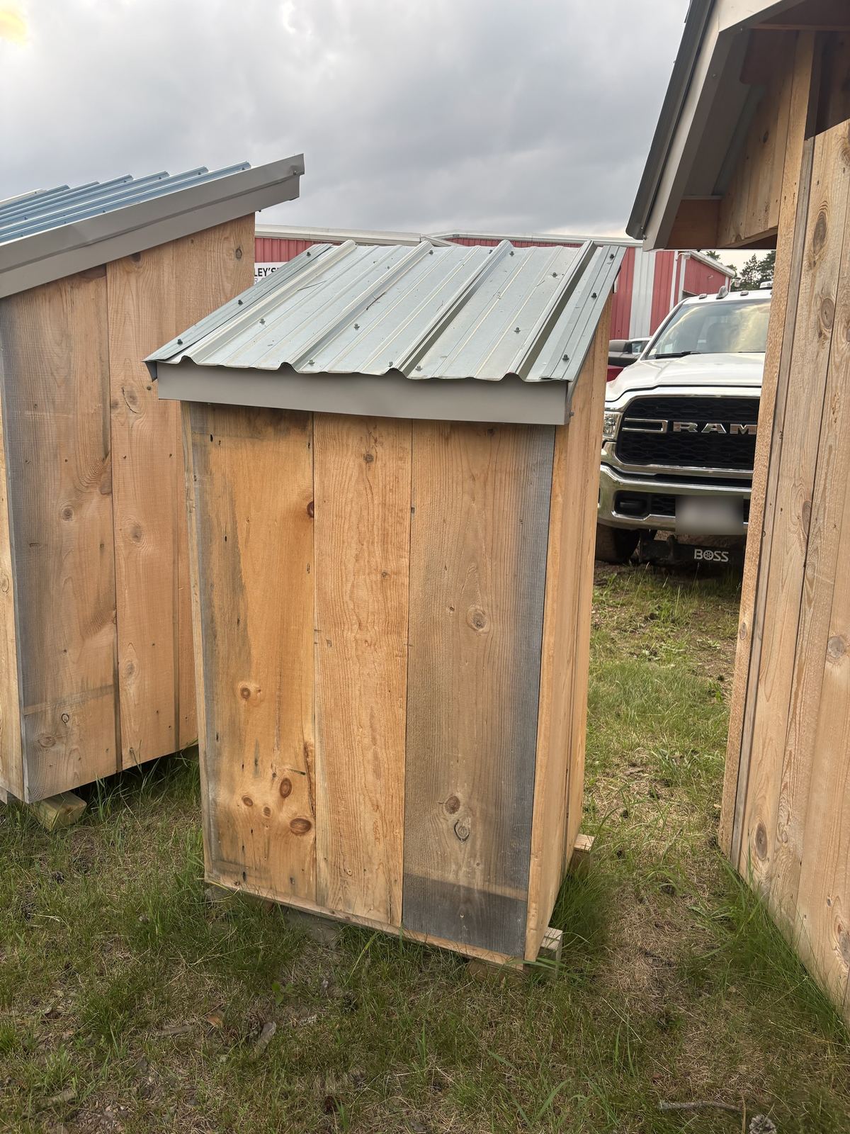 Tall single shed with a galvanized roof, seen from behind