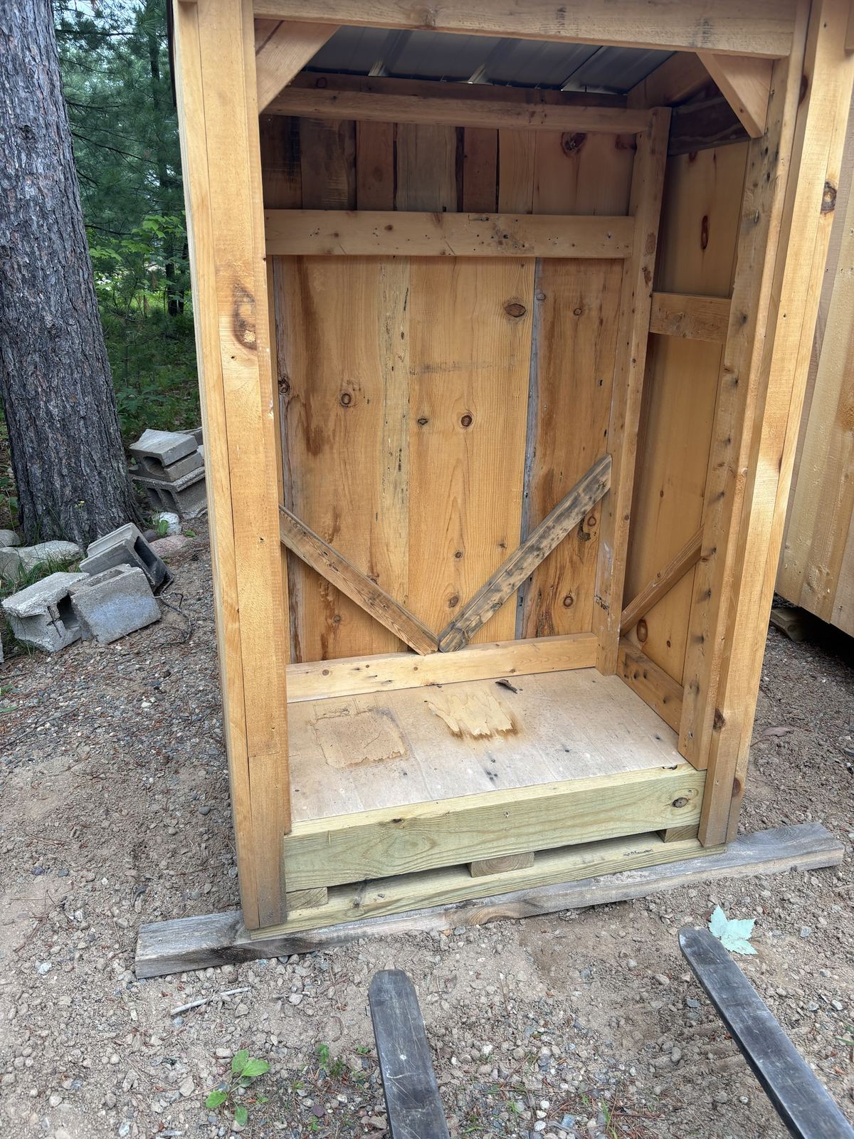 Inside a tall single shed with a V-braced back wall